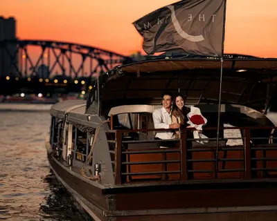 a bride and groom on a boat on the water at The Siam in Bangkok