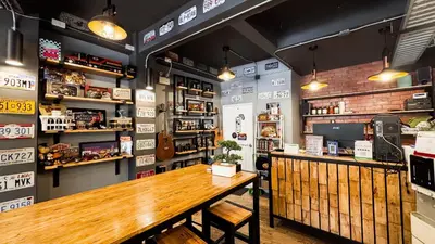 a restaurant with a wooden table in a room at Room 22 Hostel - near Chinatown in Bangkok