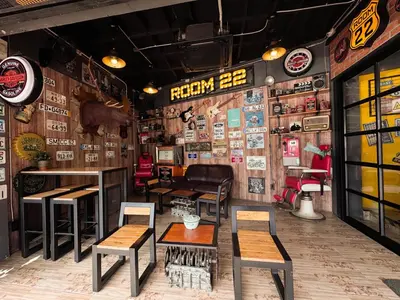 a restaurant with tables and chairs in a room at Room 22 Hostel - near Chinatown in Bangkok