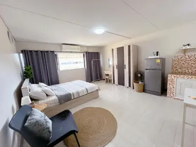 a large room with a bed and a kitchen at Condo Popular T4 Impact Muangthong by Tide in Pak Kret