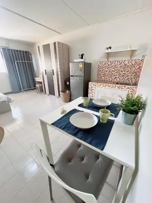 a white table with two plates on it in a living room at Condo Popular T4 Impact Muangthong by Tide in Pak Kret