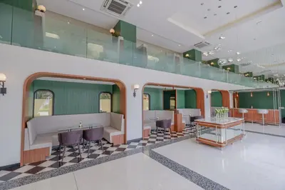 a room with a checkered floor and green walls at Justice Hotel in Bangkok