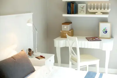 a bedroom with a desk and a bed with a chair at Cinnamon Hotel Bangkok in Bangkok