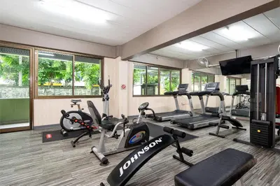 a gym with treadmills and elliptical machines at P-Park Hotel Bangkok in Bangkok
