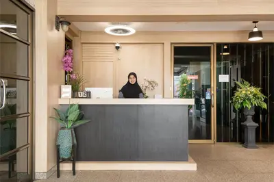 a woman sitting at a counter in a store at P-Park Hotel Bangkok in Bangkok