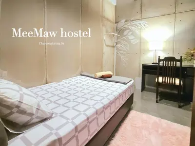 a bed in a room with a desk and a chair at MEEMAW'S House Hostel in Bangkok