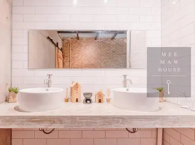 a bathroom with two sinks and a mirror at MEEMAW'S House Hostel in Bangkok