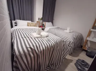 a hotel room with a bed with towels on it at White House Hostel in Bangkok