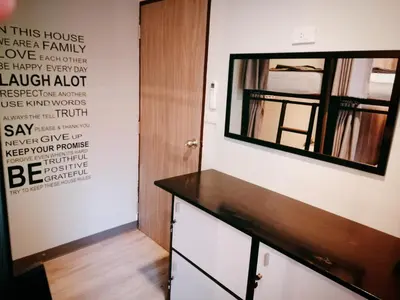 a dressing room with a mirror and a dresser at White House Hostel in Bangkok