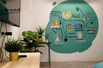 a wall with a mural of a garden at Tropical Summer Hostel in Bangkok