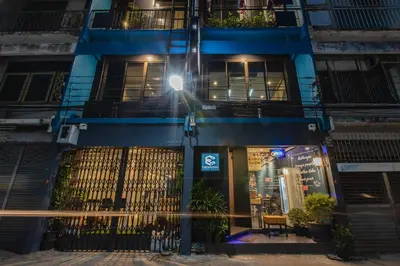 a blue building with a street light in front of it at Every Surawong in Bangkok