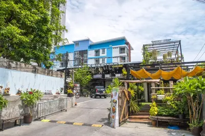 a building with a yellow canopy in the street at The Quarter Wutthakat in Bang Khun Thian