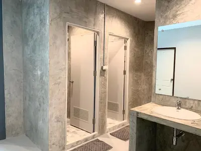 a bathroom with a sink and a mirror at Udomsuk Inn & Cafe - BTS Udomsuk in Bangkok