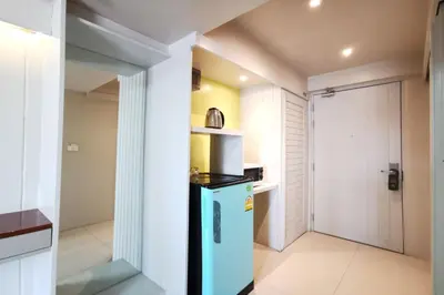 a kitchen with a blue refrigerator and a door at A Sleep Bangkok Sathorn in Bangkok