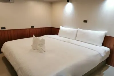 a bedroom with a large bed with white sheets and pillows at A Sleep Bangkok Sathorn in Bangkok