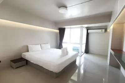 a bedroom with a bed and a large window at A Sleep Bangkok Sathorn in Bangkok