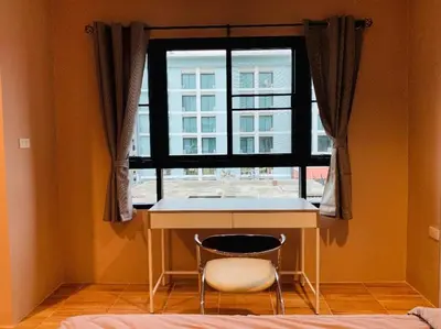 a chair sitting in front of a desk in front of a window at ICON HOSTEL in Bangkok
