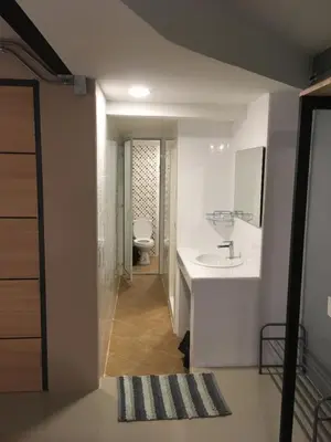 a white bathroom with a sink and a toilet at ICON HOSTEL in Bangkok