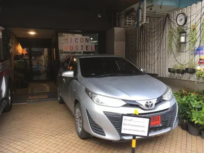 a silver car parked in front of a building at ICON HOSTEL in Bangkok