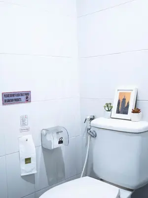 a bathroom with a toilet with a picture on the tank at Chan Cha La 99 Hostel in Bangkok