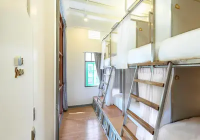 a room with a bunch of bunk beds at REST IS MORE hostel in Bangkok