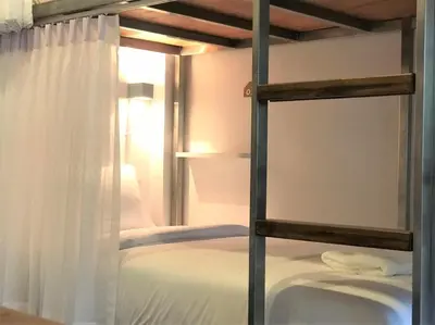 a bedroom with a bunk bed with a window at REST IS MORE hostel in Bangkok