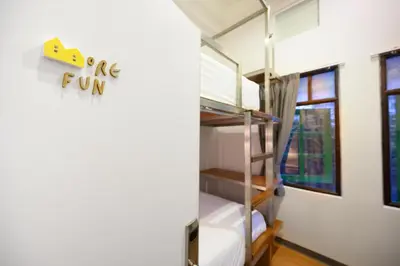 a dorm room with bunk beds and a window at REST IS MORE hostel in Bangkok