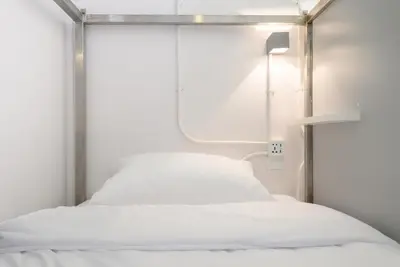 a hospital bed in a room with a window at REST IS MORE hostel in Bangkok