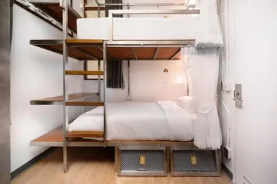 a bedroom with a bunk bed in a room at REST IS MORE hostel in Bangkok