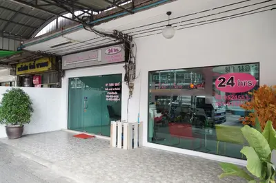 a store front with a large glass door with a hrs sign at Ma Non Nont Hotel & Apartment in Nonthaburi