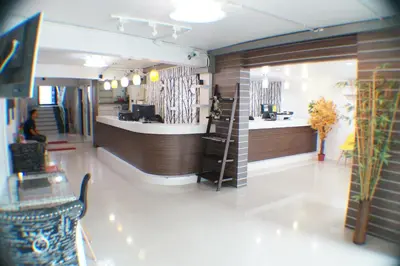 a restaurant lobby with a counter and a bar at Ma Non Nont Hotel & Apartment in Nonthaburi