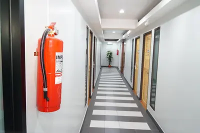 a hallway with an orange fire hydrant on the wall at Ma Non Nont Hotel & Apartment in Nonthaburi