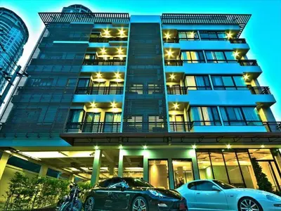 two cars parked in front of a building at The Present Sathorn in Bangkok