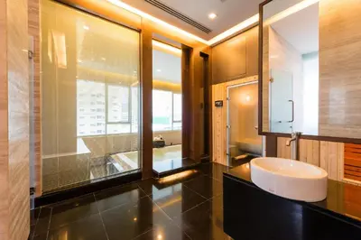 a bathroom with a sink and a mirror at Jasmine Grande Residence in Bangkok