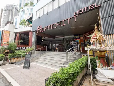a building with stairs in front of a store at Ruamchitt Plaza Hotel in Bangkok