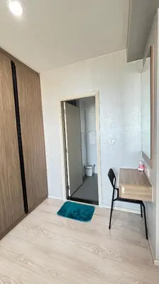 a room with a table and a chair and a mirror at The Gallery condominium in Samut Prakan
