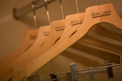 a row of wooden acoustic guitars on a rack at Hope Land Hotel Sukhumvit 24 in Bangkok