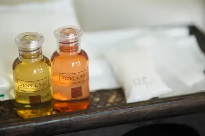 two bottles of honey jars sitting on a shelf at Hope Land Hotel Sukhumvit 24 in Bangkok