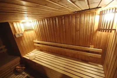 a wooden sauna with a toilet in it at Hope Land Hotel Sukhumvit 24 in Bangkok
