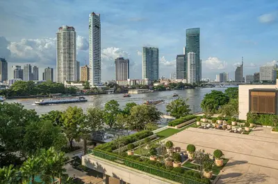 a view of a river and a city with tall buildings at Four Seasons Hotel Bangkok at Chao Phraya River in Bangkok