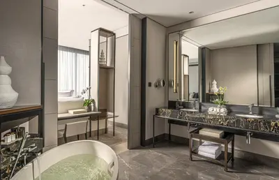 a bathroom with two sinks and a mirror at Four Seasons Hotel Bangkok at Chao Phraya River in Bangkok
