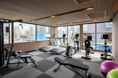 a gym with treadmills and cardio equipment in a building at Eleven Hotel Bangkok Sukhumvit 11 in Bangkok
