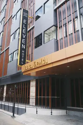 a building with a sign on the side of it at Eleven Hotel Bangkok Sukhumvit 11 in Bangkok