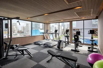 a gym with treadmills and cardio equipment in a building at Eleven Hotel Bangkok Sukhumvit 11 in Bangkok