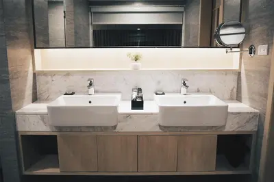a bathroom with two sinks and a large mirror at Eleven Hotel Bangkok Sukhumvit 11 in Bangkok