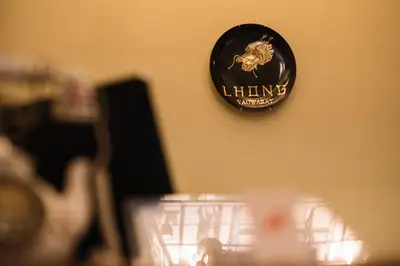 a sign on a wall that says lifting workers at Lhong Yaowarat hostel in Bangkok