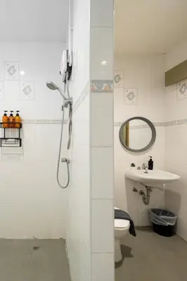 a bathroom with a shower and a toilet and a sink at Bai Bua House Chatuchak in Ban Zong Katiam