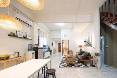 a living room with a couch and a table at Bai Bua House Chatuchak in Ban Zong Katiam