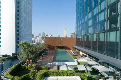 an overhead view of a building with a pool and chairs at Carlton Hotel Bangkok Sukhumvit in Bangkok