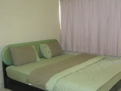 a bed with two pillows on it in a bedroom at Poppular Palace Don Mueang Bangkok in Bangkok